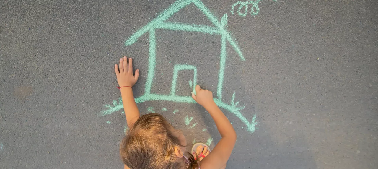 child-draws-chalk-house-selective-focus